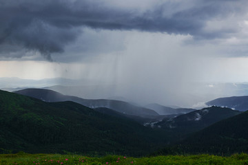 Obraz na płótnie Canvas Rain falls far away. Majestic Carpathian mountains. Beautiful landscape. Breathtaking view