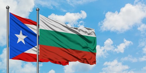 Puerto Rico and Bulgaria flag waving in the wind against white cloudy blue sky together. Diplomacy concept, international relations.