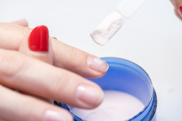 The process of professional manicure and preparation for applying gel polish. Macro photo of female fingers.