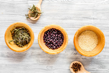 Dry colorful spices, salt, pepper on kitchen light table background top view