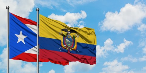 Puerto Rico and Ecuador flag waving in the wind against white cloudy blue sky together. Diplomacy concept, international relations.