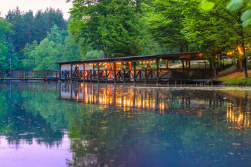 Restaurant on the water, lake in the forest.