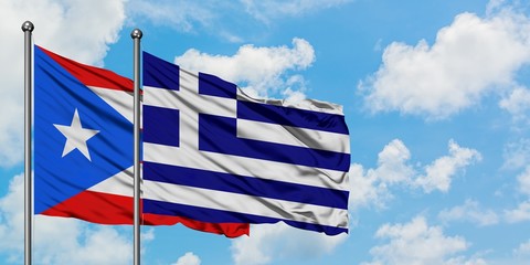 Puerto Rico and Greece flag waving in the wind against white cloudy blue sky together. Diplomacy...
