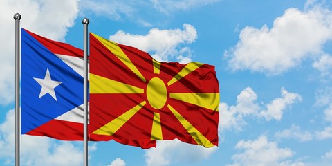 Puerto Rico and Macedonia flag waving in the wind against white cloudy blue sky together. Diplomacy...