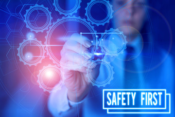 Writing note showing Safety First. Business concept for used to say that the most important thing is to be safe Picture photo network scheme with modern smart device
