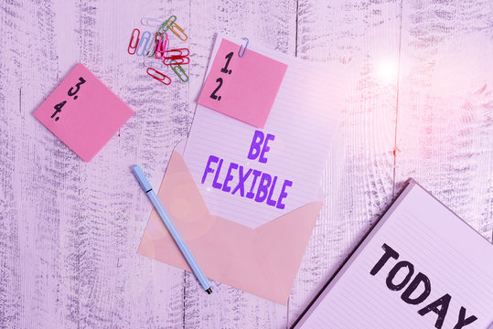 Word writing text Be Flexible. Business photo showcasing able to be easily modified to respond to altered circumstances Envelope sheet paper sticky notes ballpoint notepad clips wooden background