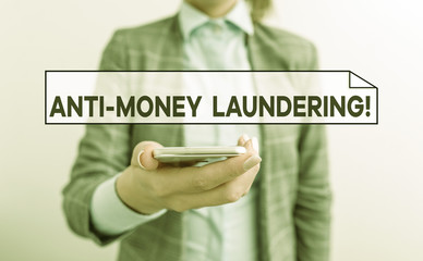 Handwriting text Anti Money Laundering. Conceptual photo regulations stop generating income through illegal actions Business concept with mobile phone and business woman