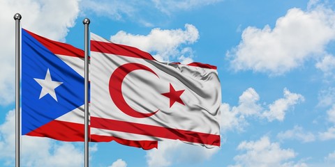 Puerto Rico and Northern Cyprus flag waving in the wind against white cloudy blue sky together. Diplomacy concept, international relations.