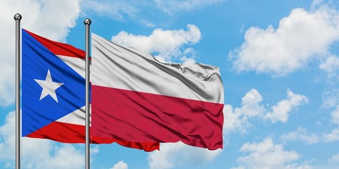 Puerto Rico and Poland flag waving in the wind against white cloudy blue sky together. Diplomacy concept, international relations.