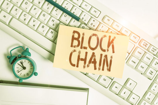 Conceptual hand writing showing Block Chain. Concept meaning system in which a record of transactions made in bitcoin Flat lay above empty note paper on pc keyboard pencils and clock - Powered by Adobe