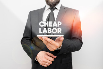 Word writing text Cheap Labor. Business photo showcasing when a demonstrating works hard in bad conditions and very little money Male human wear formal work suit hold smart hi tech smartphone use one