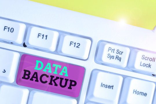 Word writing text Data Backup. Business photo showcasing copy of important data that is stored on an alternative location White pc keyboard with empty note paper above white background key copy space