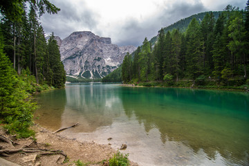 Lake Lago di Braies in Dolomiti mountains, South Tyrol, Italy. Dock with romantic old wooden rowing boats on lake. Amazing view of Lago di Braies.