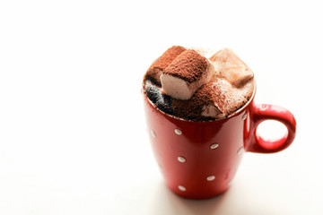 Hot cocoa with marshmallows and a straw on top of chocolate. Christmas drink. Place for text, copywriting. Hot chocolate with marshmallows in a New Year's cup