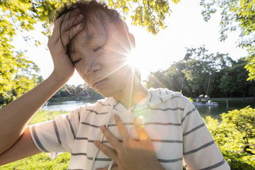 Tired asian woman suffer from sunburn very hot in summer weather problem feel...