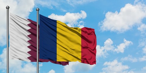 Qatar and Chad flag waving in the wind against white cloudy blue sky together. Diplomacy concept,...
