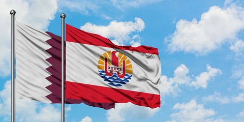 Qatar and French Polynesia flag waving in the wind against white cloudy blue sky together....