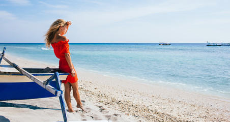 Young blonde woman looking at sea