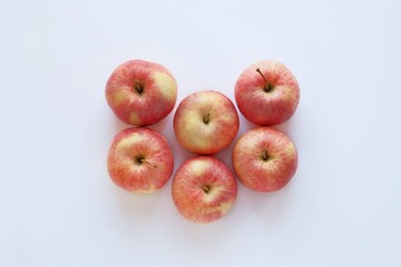 Red ripe apples close-up on a white background. Top view.