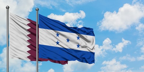 Qatar and Honduras flag waving in the wind against white cloudy blue sky together. Diplomacy concept, international relations.