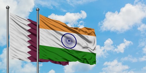 Qatar and India flag waving in the wind against white cloudy blue sky together. Diplomacy concept,...