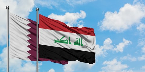 Qatar and Iraq flag waving in the wind against white cloudy blue sky together. Diplomacy concept, international relations.