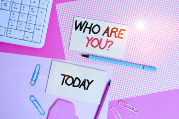 Fototapeta premium Word writing text Who Are Youquestion. Business photo showcasing someone asking your demonstratingal background or history Writing equipments and computer stuffs placed above colored plain table