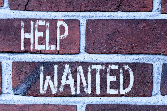 Writing note showing Help Wanted. Business concept for An ad in the paper an employer places to find a new employee Front view red brick wall facade background Old grunge scenery