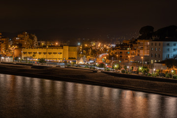 Blanes fotografia nocturna con vistas al mar y ciudad iluminada reflejos en el agua 