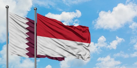 Qatar and Monaco flag waving in the wind against white cloudy blue sky together. Diplomacy concept,...