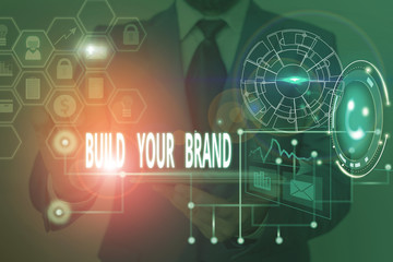 Writing note showing Build Your Brand. Business concept for enhancing brand equity using advertising campaigns Picture photo network scheme with modern smart device