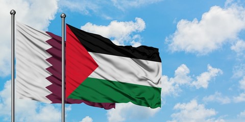 Qatar and Palestine flag waving in the wind against white cloudy blue sky together. Diplomacy concept, international relations.