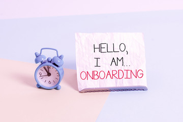 Conceptual hand writing showing Hello I Am Onboarding. Concept meaning telling demonstrating that you are on ship or plane Alarm clock beside a Paper sheet placed on pastel backdrop