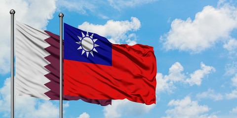 Qatar and Taiwan flag waving in the wind against white cloudy blue sky together. Diplomacy concept, international relations.