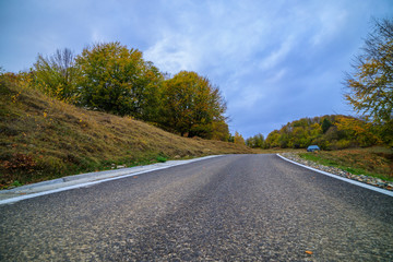 Fototapeta na wymiar mountain road during autumn on a cloudy day