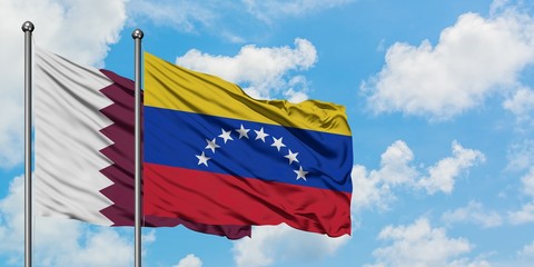 Qatar and Venezuela flag waving in the wind against white cloudy blue sky together. Diplomacy concept, international relations.