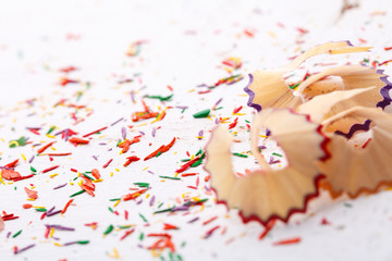 Shavings from colored pencils on a white background