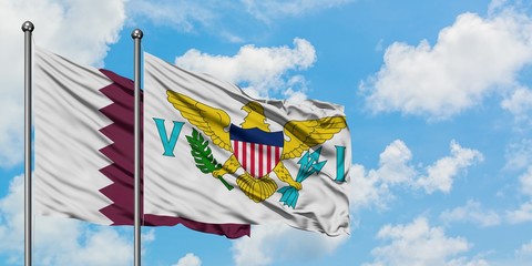 Qatar and United States Virgin Islands flag waving in the wind against white cloudy blue sky...