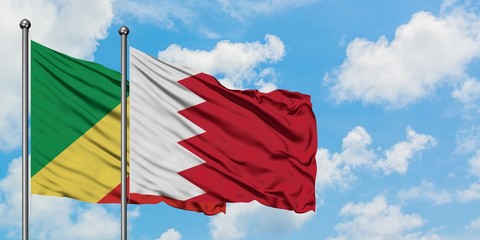 Republic Of The Congo and Bahrain flag waving in the wind against white cloudy blue sky together. Diplomacy concept, international relations.