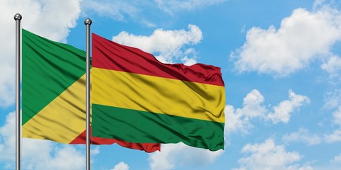 Republic Of The Congo and Bolivia flag waving in the wind against white cloudy blue sky together. Diplomacy concept, international relations.