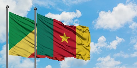 Republic Of The Congo and Cameroon flag waving in the wind against white cloudy blue sky together. Diplomacy concept, international relations.