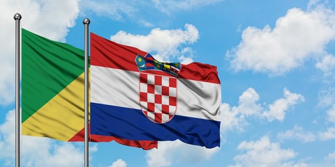 Republic Of The Congo and Croatia flag waving in the wind against white cloudy blue sky together. Diplomacy concept, international relations.