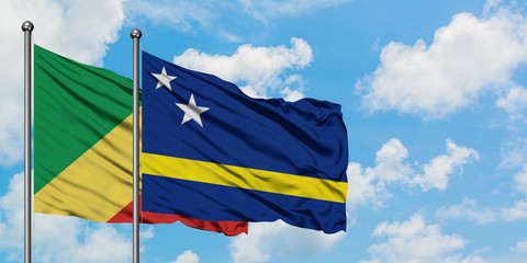 Republic Of The Congo and Curacao flag waving in the wind against white cloudy blue sky together. Diplomacy concept, international relations.