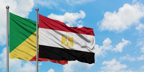 Republic Of The Congo and Egypt flag waving in the wind against white cloudy blue sky together. Diplomacy concept, international relations.