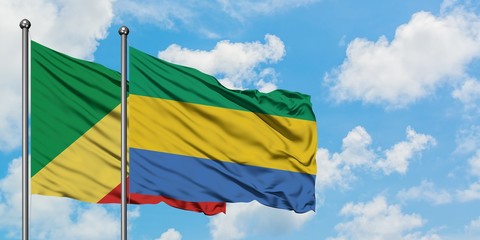 Republic Of The Congo and Gabon flag waving in the wind against white cloudy blue sky together. Diplomacy concept, international relations.