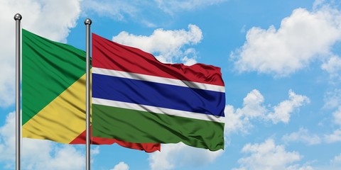 Republic Of The Congo and Gambia flag waving in the wind against white cloudy blue sky together....