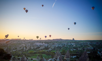 Sunrise panoramic view to Goreme city and flying balloons, Cappadocia, Turkey