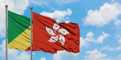 Republic Of The Congo and Hong Kong flag waving in the wind against white cloudy blue sky together....