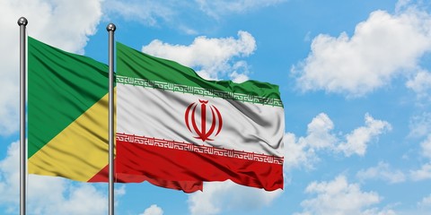 Republic Of The Congo and Iran flag waving in the wind against white cloudy blue sky together. Diplomacy concept, international relations.