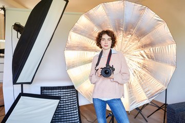 Photographer with camera and studio lights